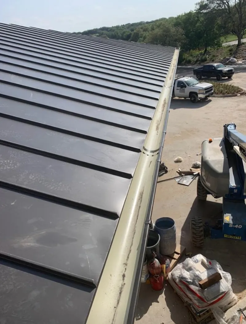 Standing seam panel and gutter detail on a metal roofing jobsite in Port St. Lucie
